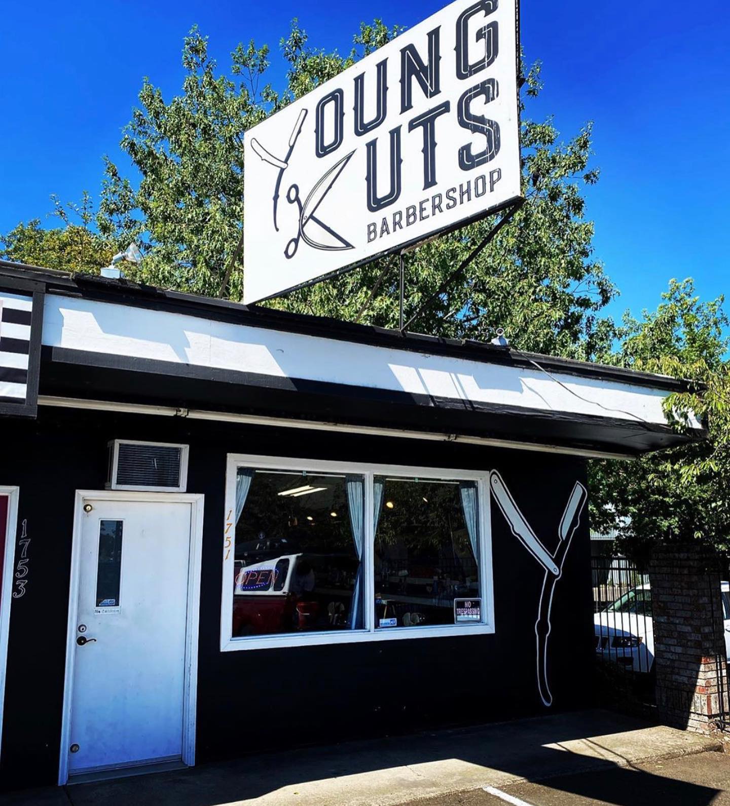 Barber at work inside Young Cutz Barbershop